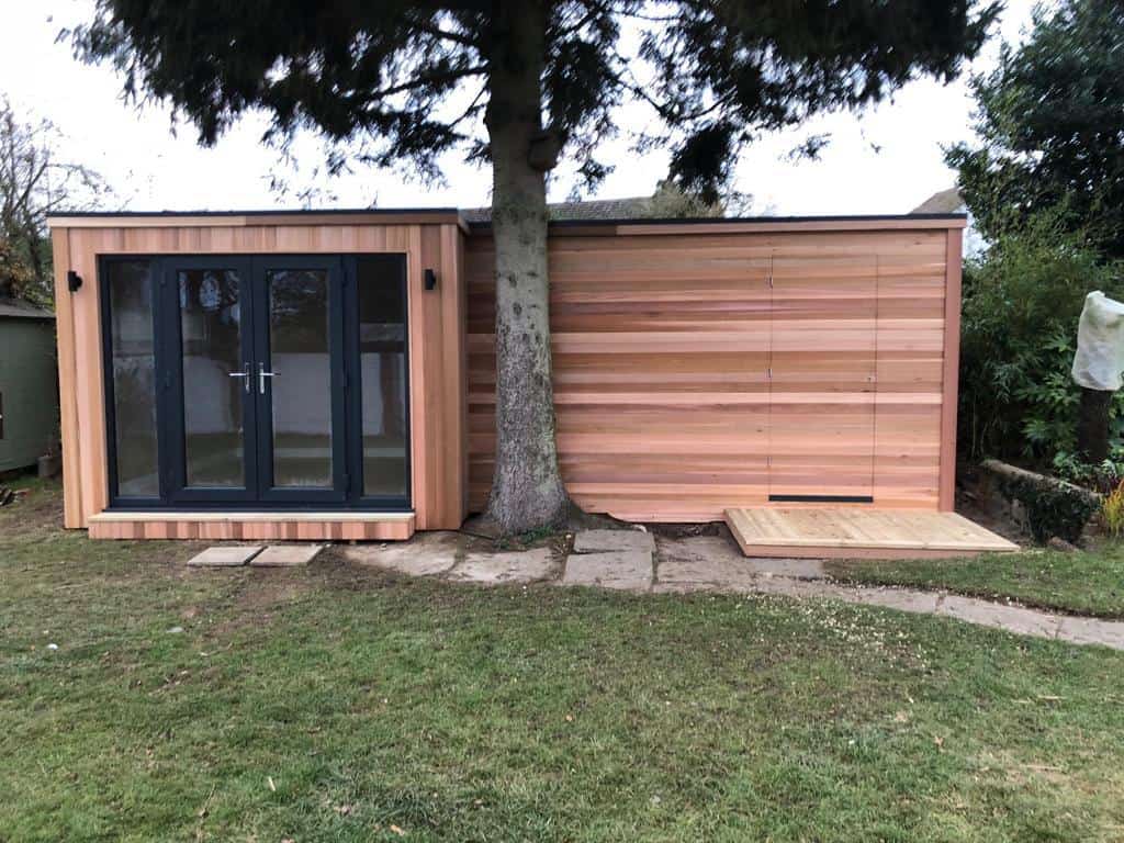 Bespoke ‘L’ shaped cedar clad garden room, with intergrated shed and a hidden cedar door