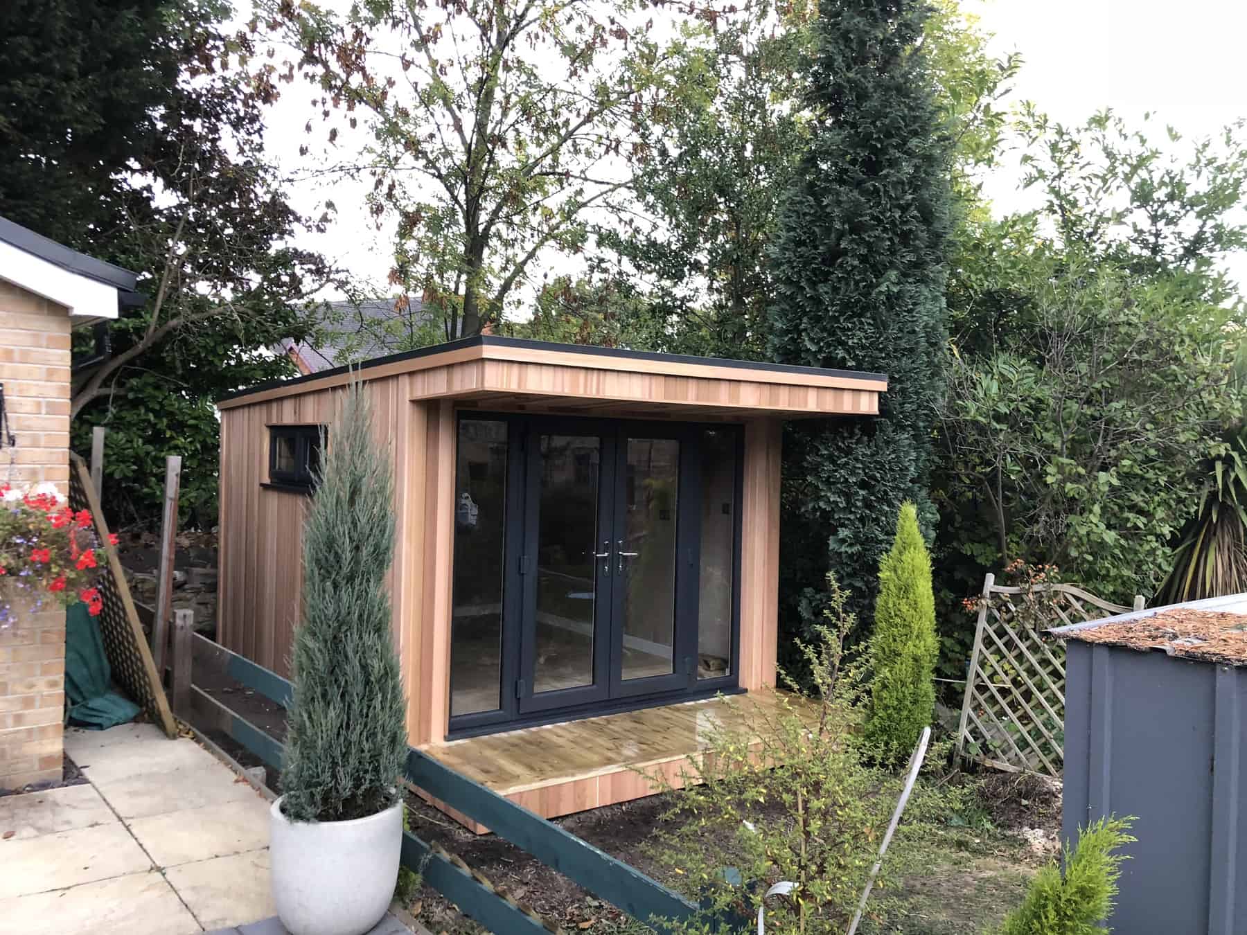 Home Garden Office neatly sitting at the bottom of narrow garden, blending in well the the surrounding environment